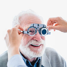 Elderly male having a home eye test