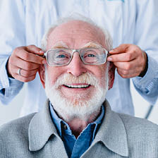 Happy mature male trying on his new glasses